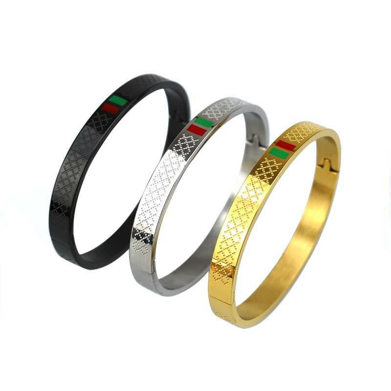 Gucci-style stainless steel bangles*, known for their sleek, modern design with a signature red-green stripe.